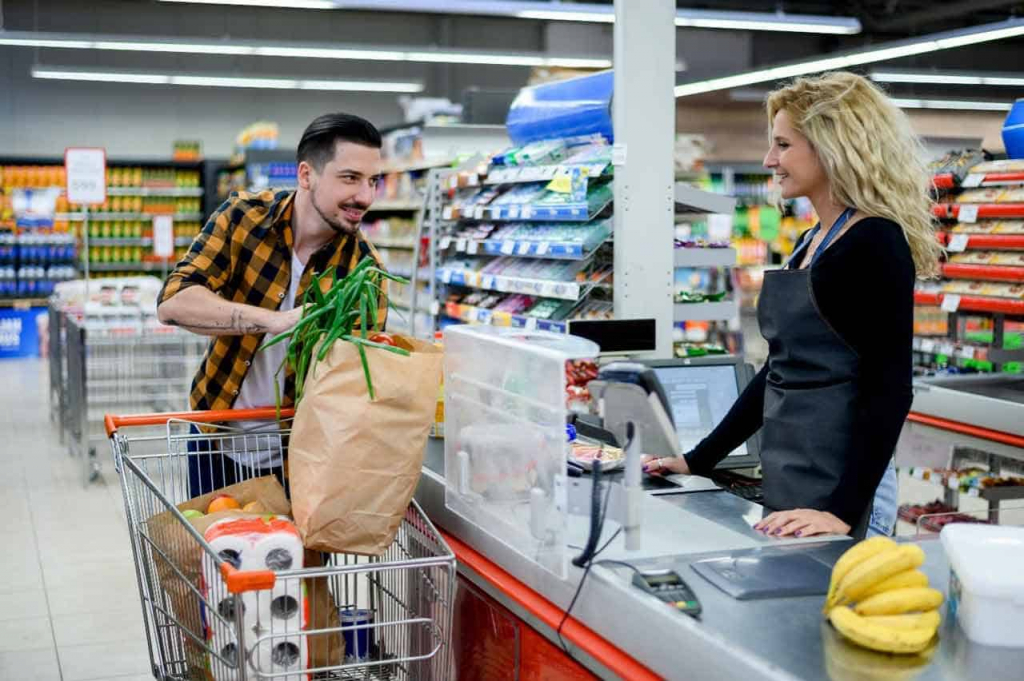 A-Staff-Dealing-with-Customer-at-Checkout-Counter-in-Supermarket.jpg